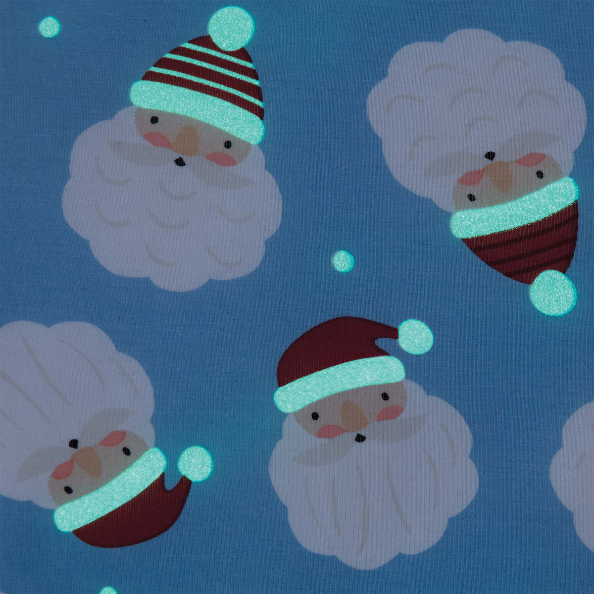 Close-up of Santa face print on blue fabric with glowing accents.