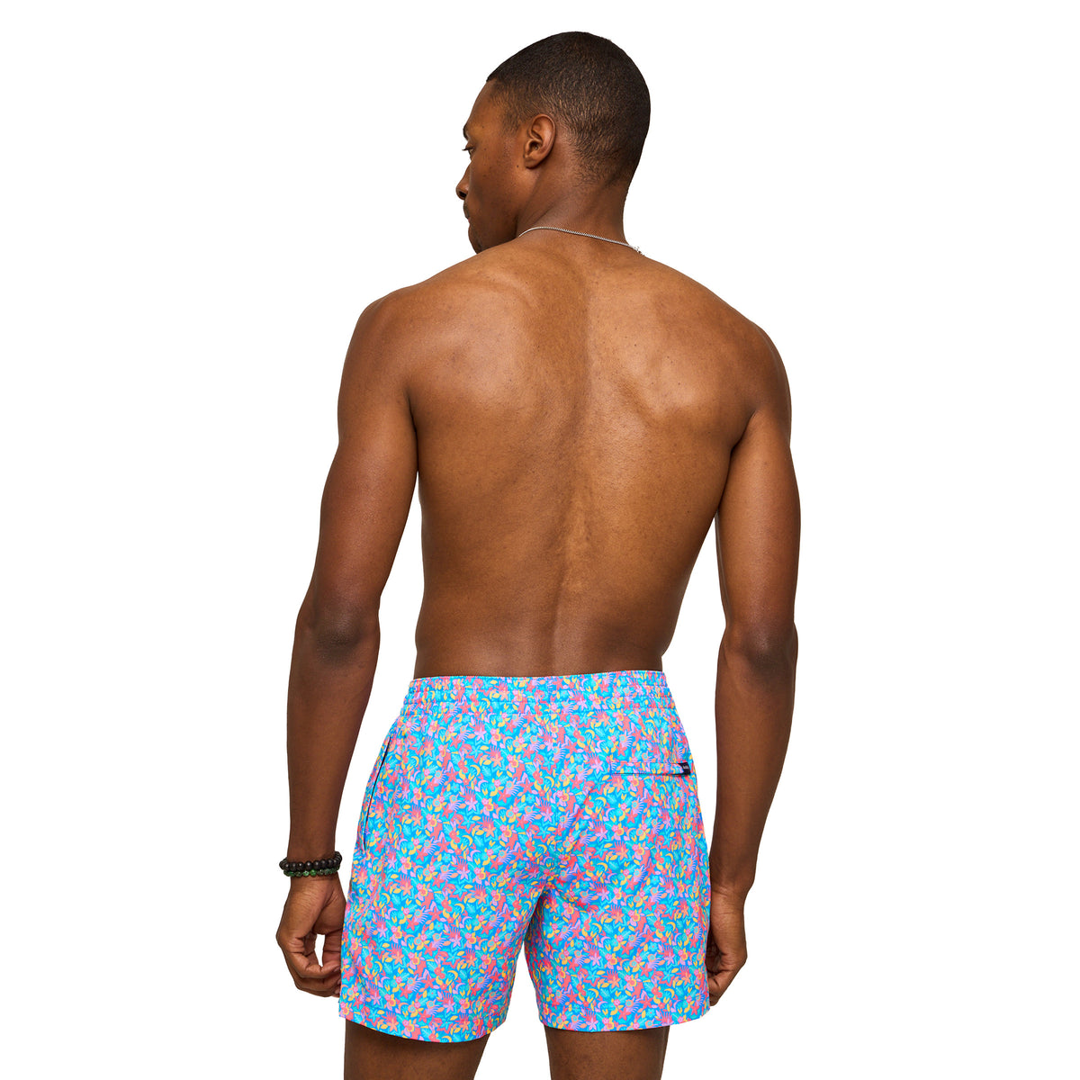 Man wearing colorful Chubbies swim shorts on a white background