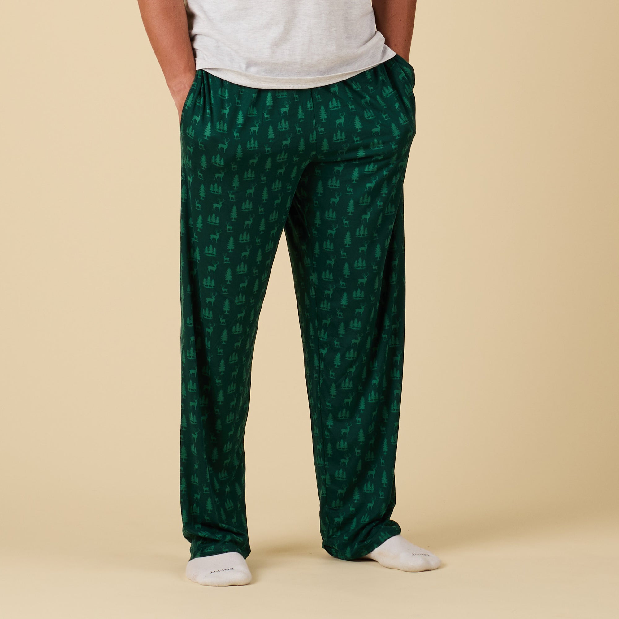 Green patterned pants worn by a person on a beige background
