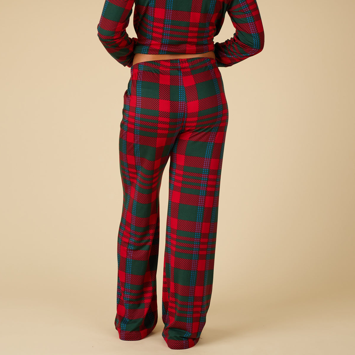 Red and green plaid pajama set on a beige background