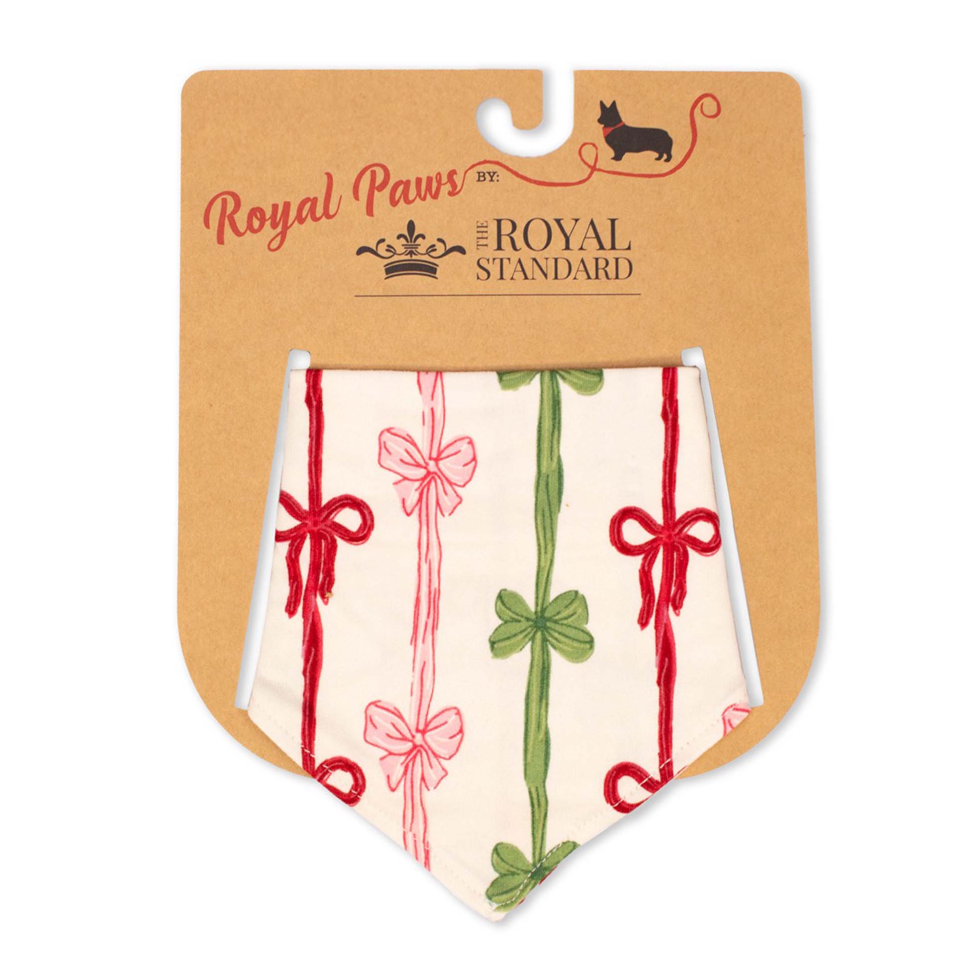 Royal Paws All Wrapped Up Dog Bandana with red, green, and pink bow designs arranged like ribbons on a cream background.