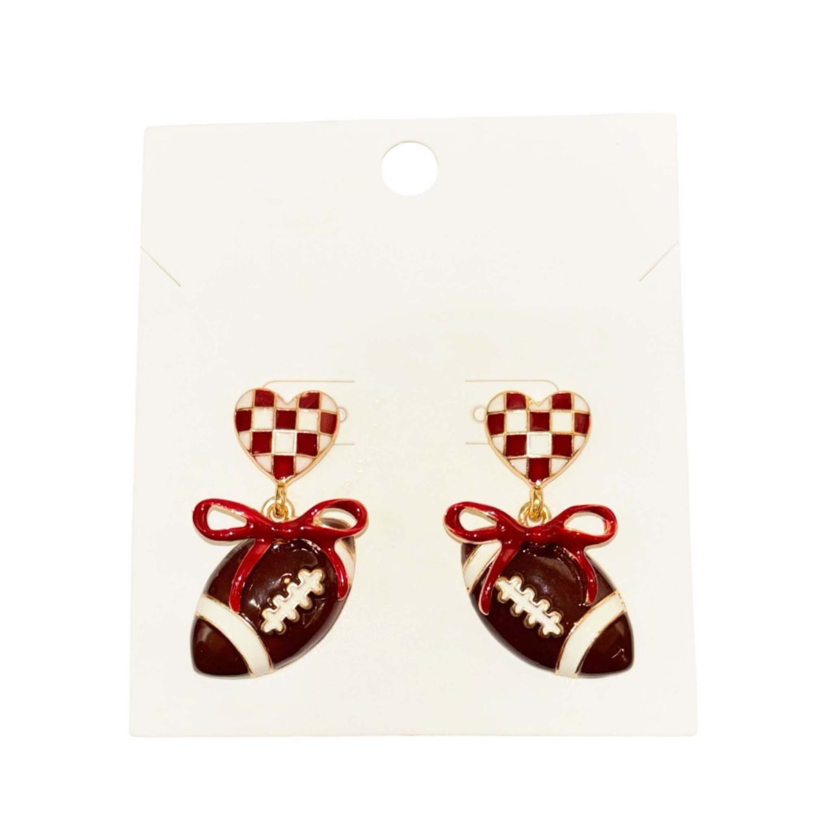 crimson and white checkered heart stud earrings featuring dangling football charms tied with crimson bows.