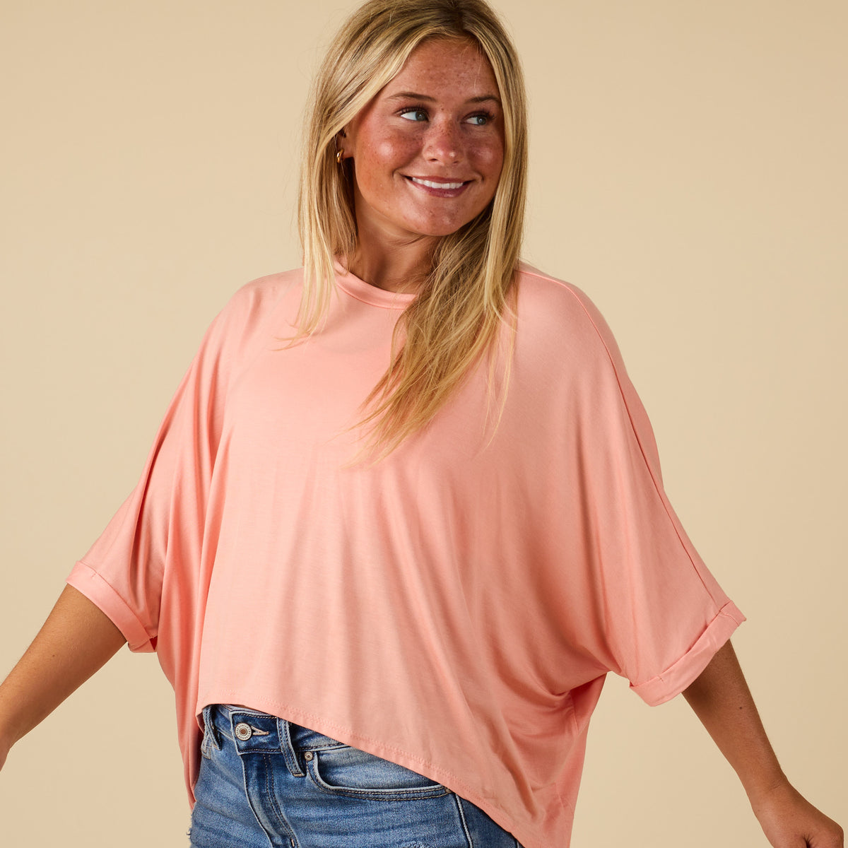 Model wearing hi lo peach short sleeve top with relaxed fit, shown from front 
