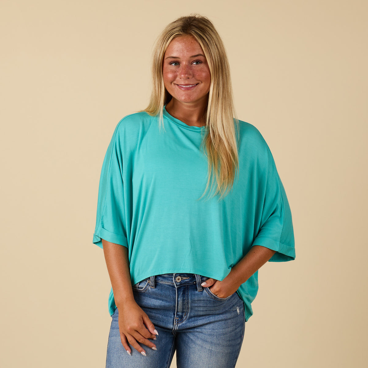 Model wearing hi lo seafoam short sleeve top with relaxed fit, shown from front 