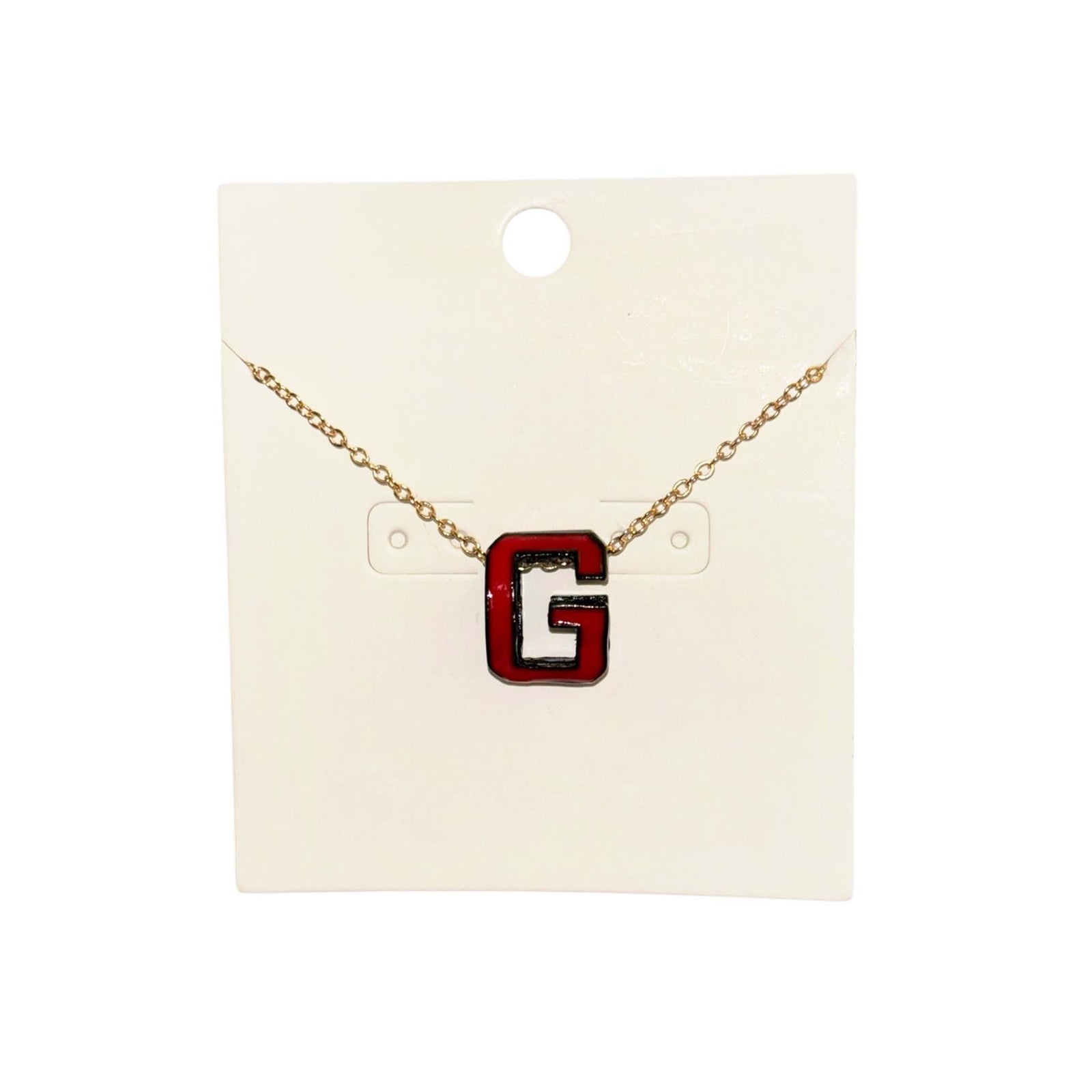 Gold chain necklace with red and black “G” pendant.
