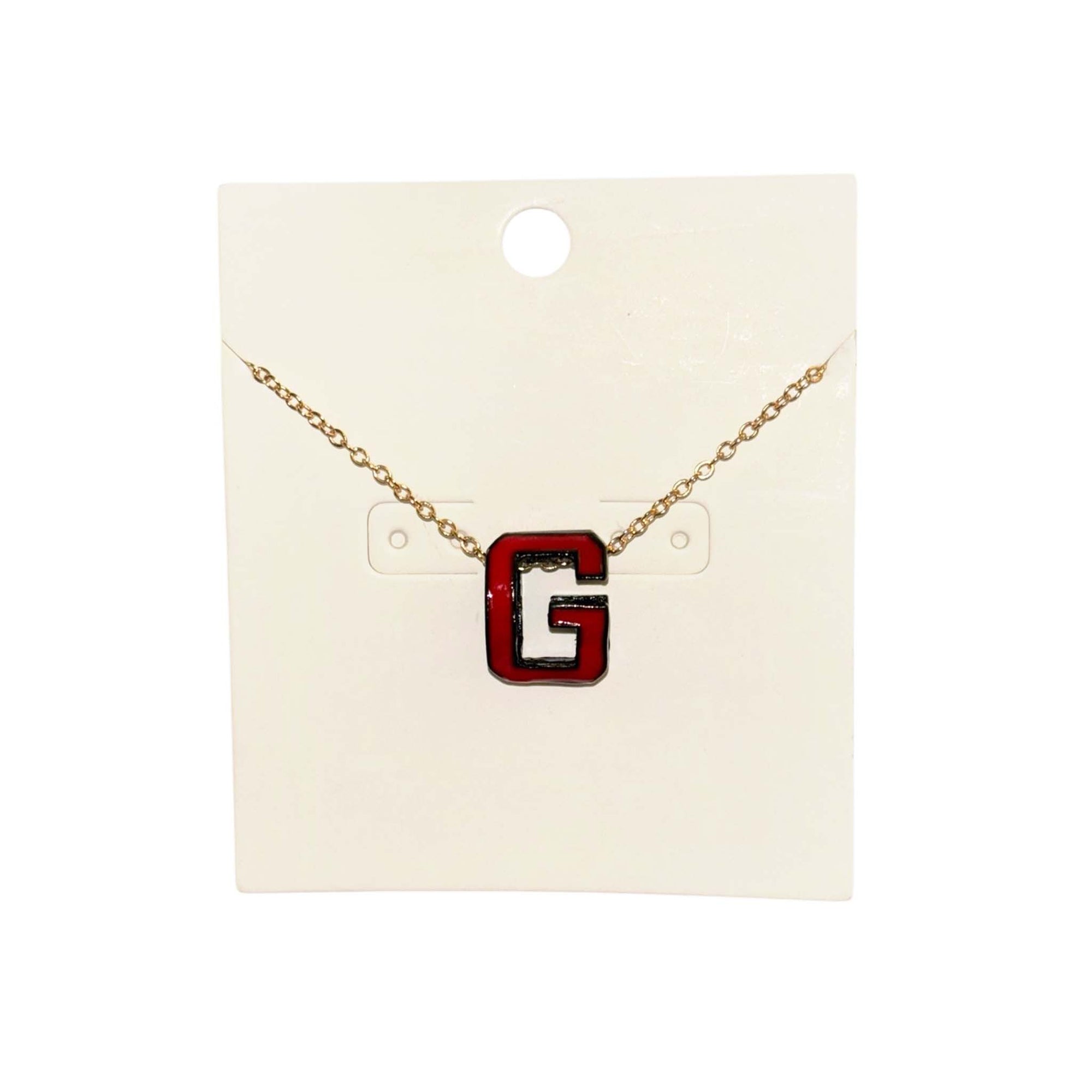 Gold chain necklace with red and black “G” pendant.