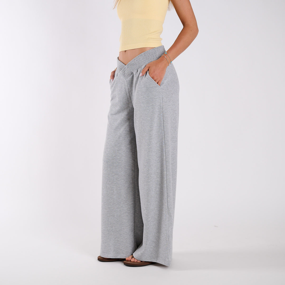 Grey | Person wearing gray wide-leg pants on a white background