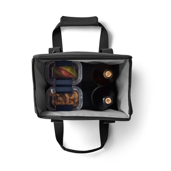 Overhead view of YETI Daytrip 14L Tote Bag in Black filled with two wine bottles and two food containers.