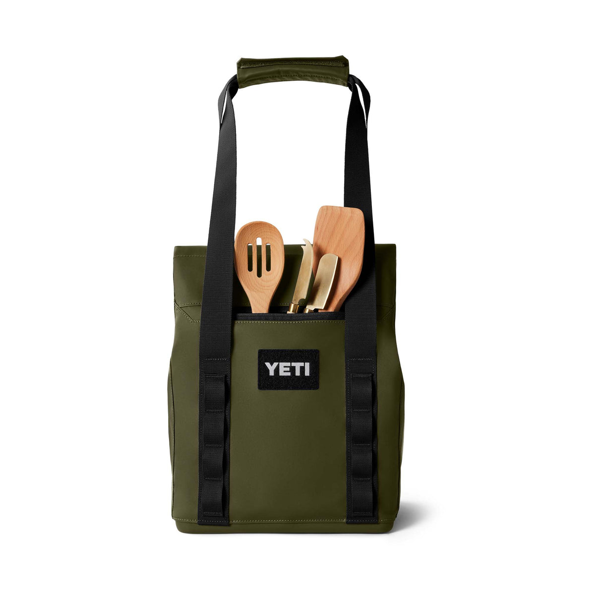 Front view of the YETI Daytrip 14L Tote Bag in Olive with front pocket holding grilling utensils.