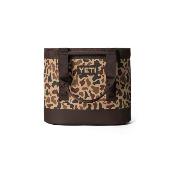 Full front view of YETI Camino 35 in Wetlands Camo with brown base and sturdy carry handles.