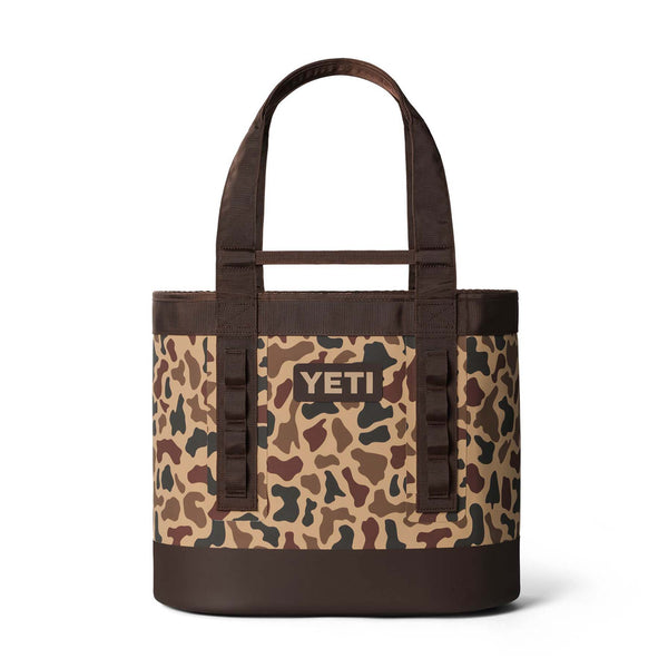 Front view of YETI Camino 35 tote in Wetlands Camo with black logo patch and dual padded carry handles.