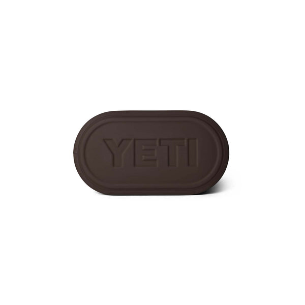 Oval-shaped brown molded base of the YETI Camino 35 tote with embossed YETI logo.