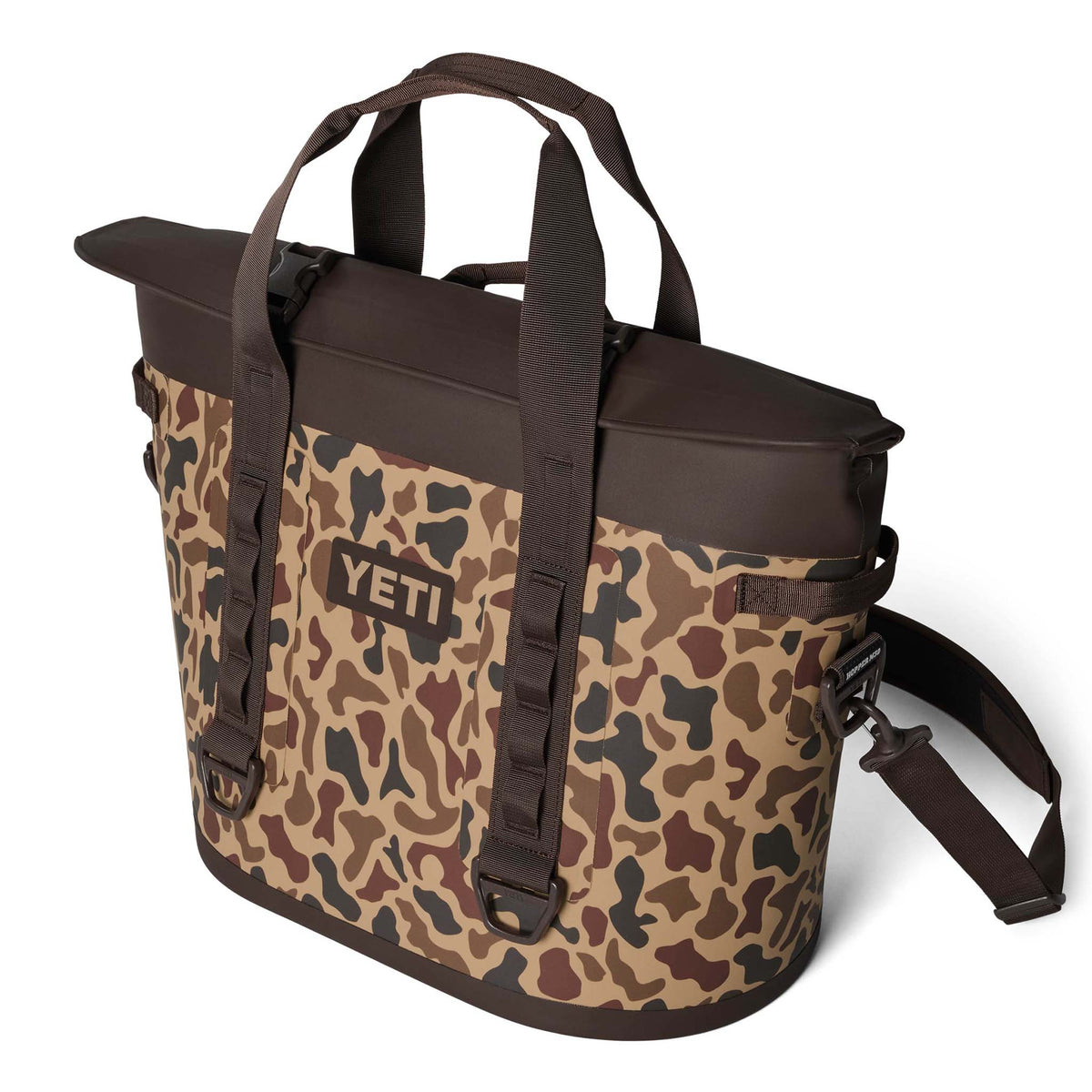 Three-quarter view of YETI Hopper M30 2.0 in Wetlands Camo with shoulder strap and top handles visible.