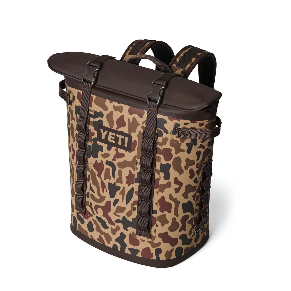 YETI Camino 50L Carryall in Wetlands Camo shown at an angle with brown top flap and shoulder straps.