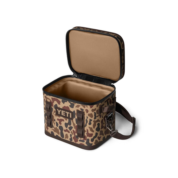 Angled top-down view of YETI Hopper Flip 12 cooler with shoulder strap with top open.