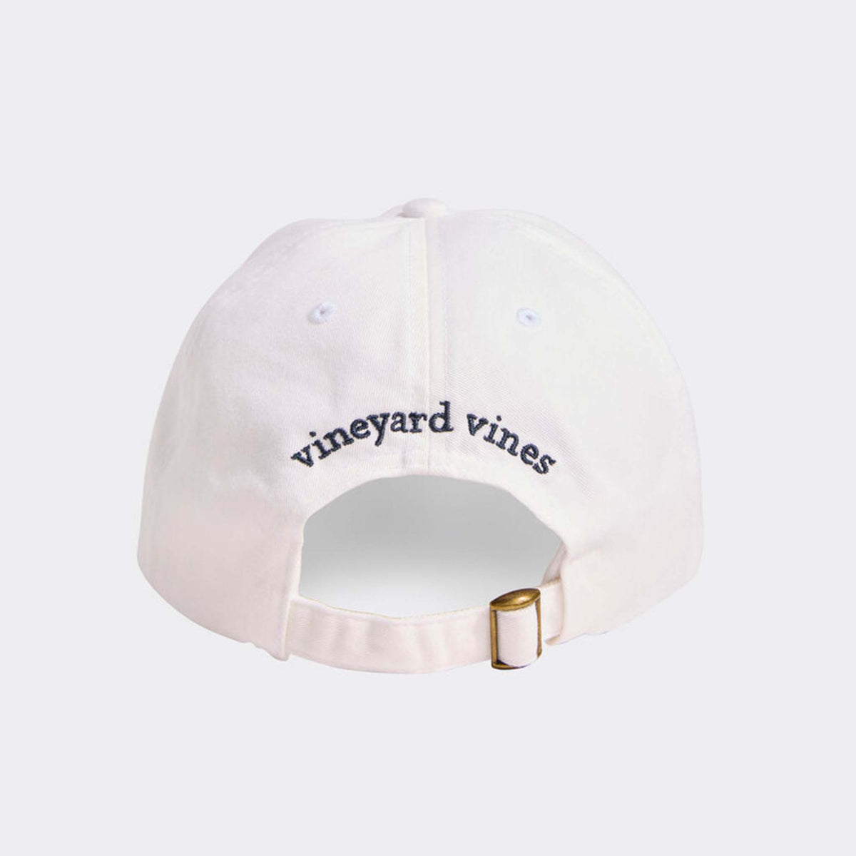 Back view of Vineyard Vines white cap with curved brim, adjustable strap, and navy “vineyard vines” embroidery.