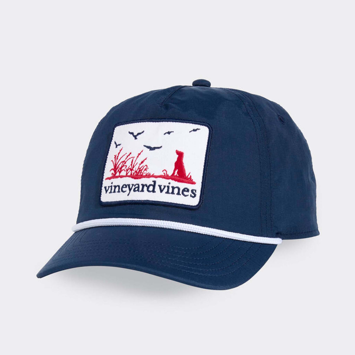 Vineyard Vines Dog Patch Trucker Hat in Moonshine with navy crown, curved bill, white rope detail, and embroidered outdoor scene patch.