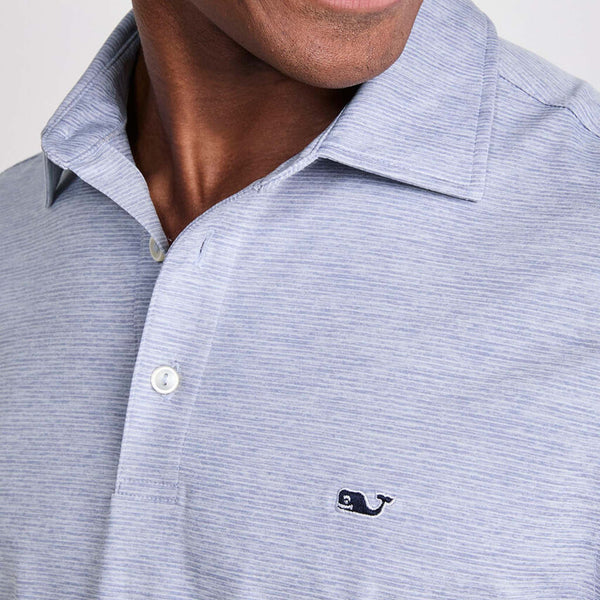 Vineyard Vines Men's Short Sleeve Polo in Hammerhead, sizes S-XXL. Close-up of chest showing buttons and stitched whale logo on striped fabric. Color is a muted blue and white small stripes.