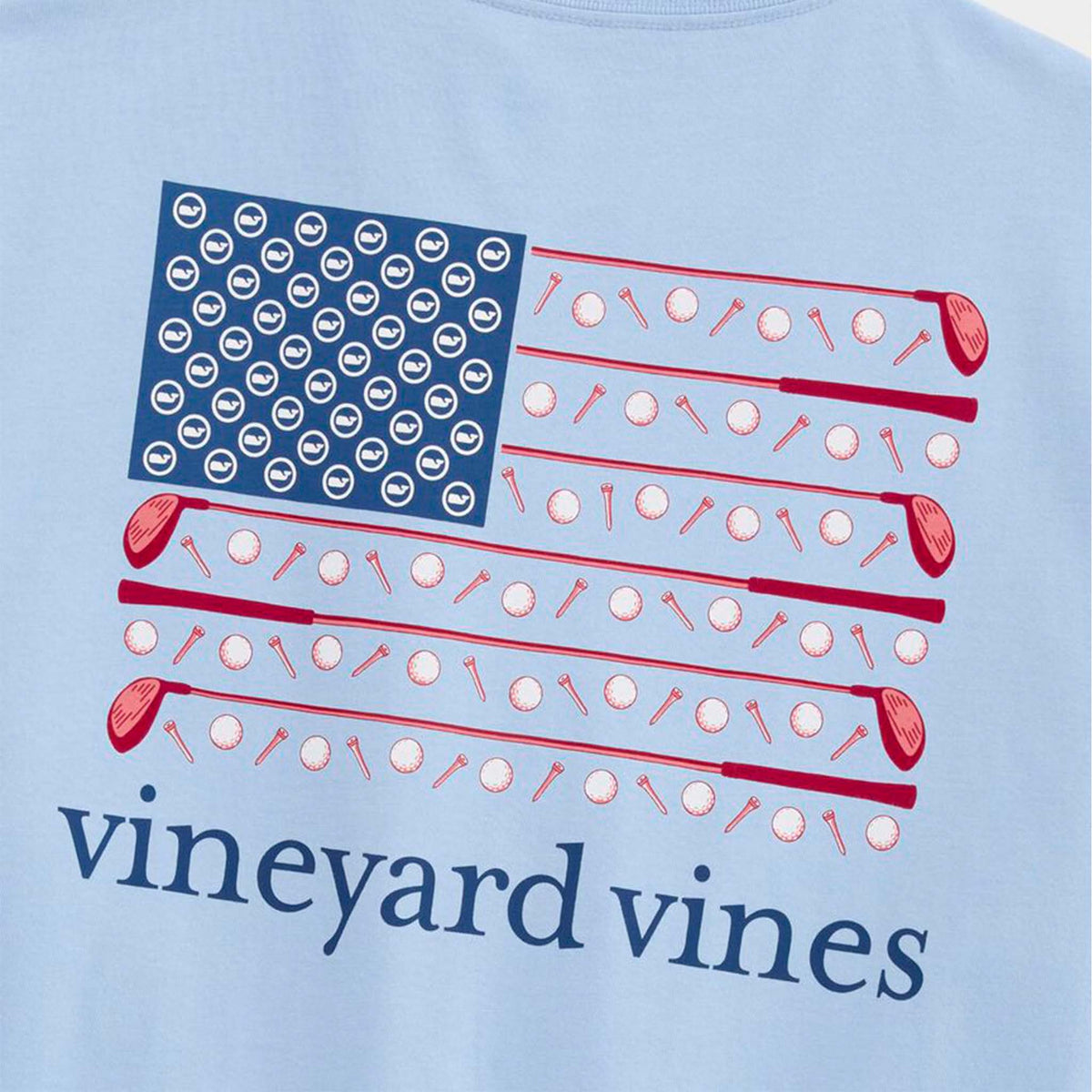 Light blue t-shirt with American flag design featuring golf clubs and balls, and 'vineyard vines' branding.