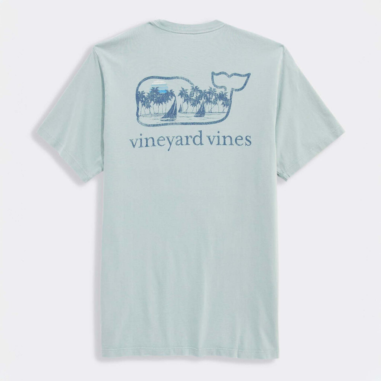 Back view of light blue Vineyard Vines t-shirt with large blue whale logo graphic. The whale contains palm trees, sailboats, and a sun.