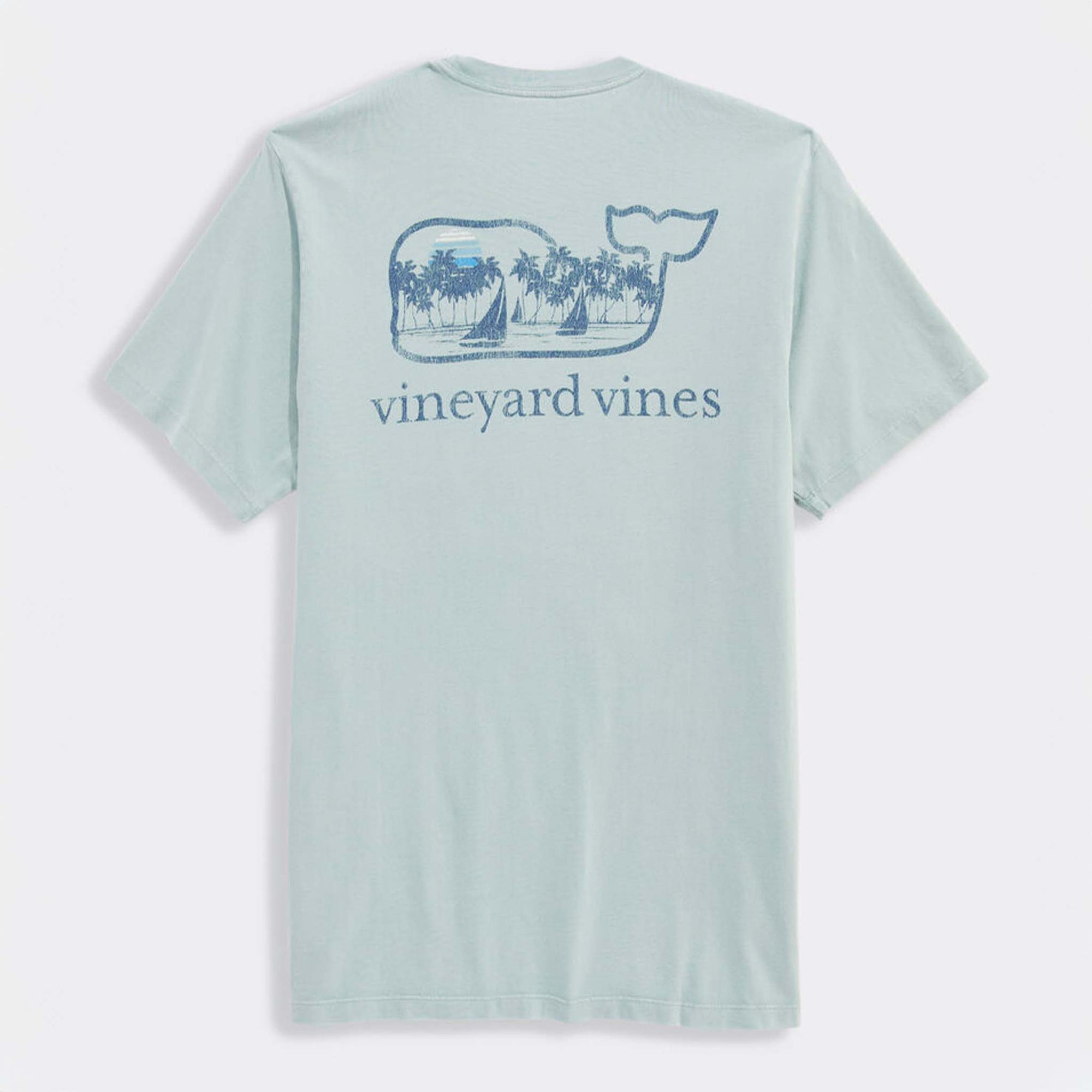 Back view of light blue Vineyard Vines t-shirt with large blue whale logo graphic. The whale contains palm trees, sailboats, and a sun.