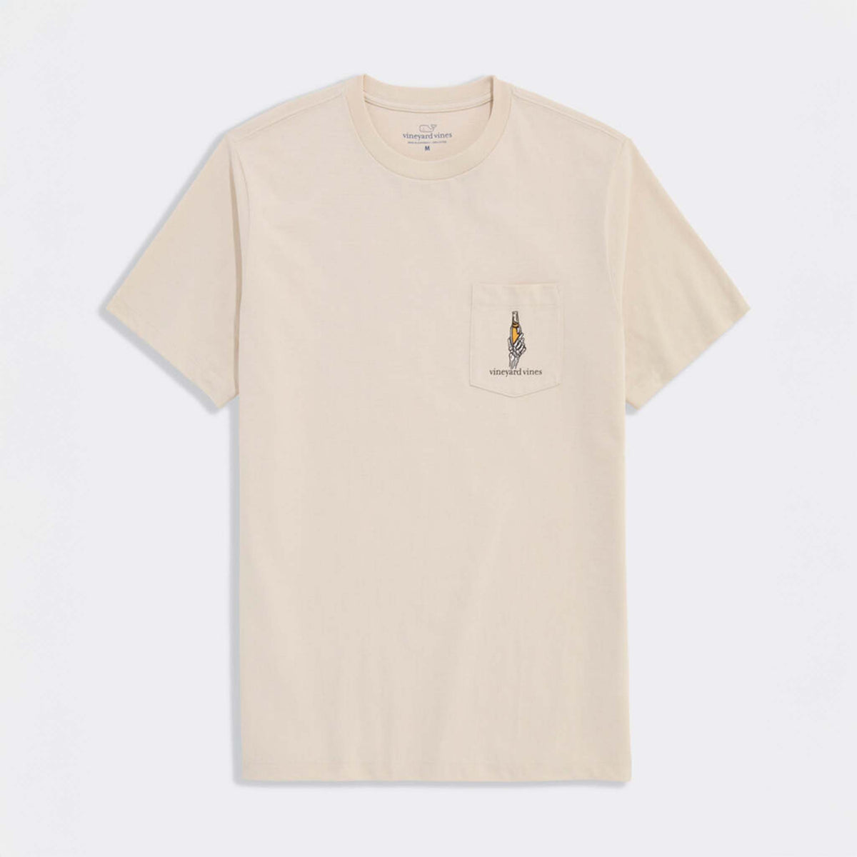 Front view of stone-colored Vineyard Vines short sleeve pocket t-shirt with skeleton hand holding a drink graphic on pocket.