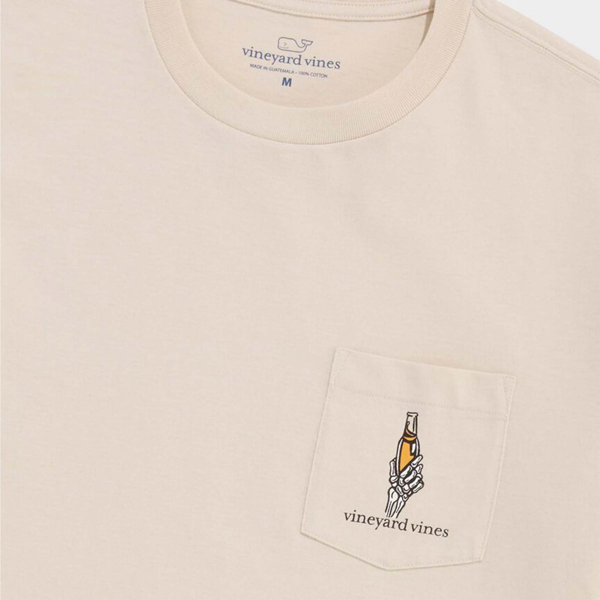 Close-up of pocket design featuring skeleton hand holding a beer bottle above Vineyard Vines logo.