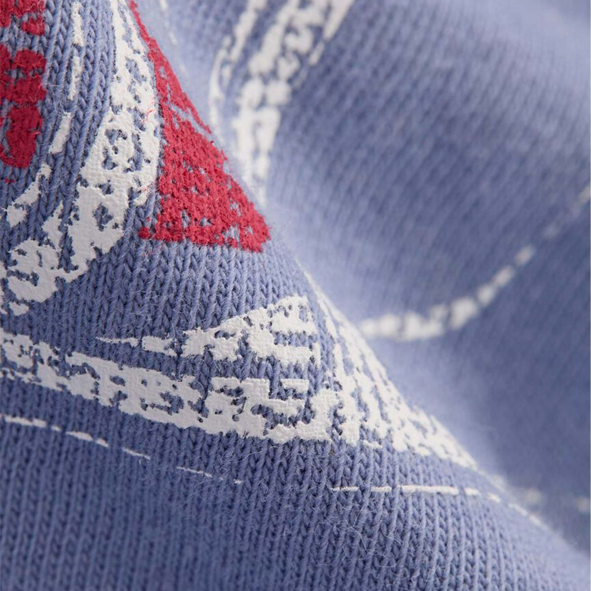 Close-up of a blue sock with red and white patterns