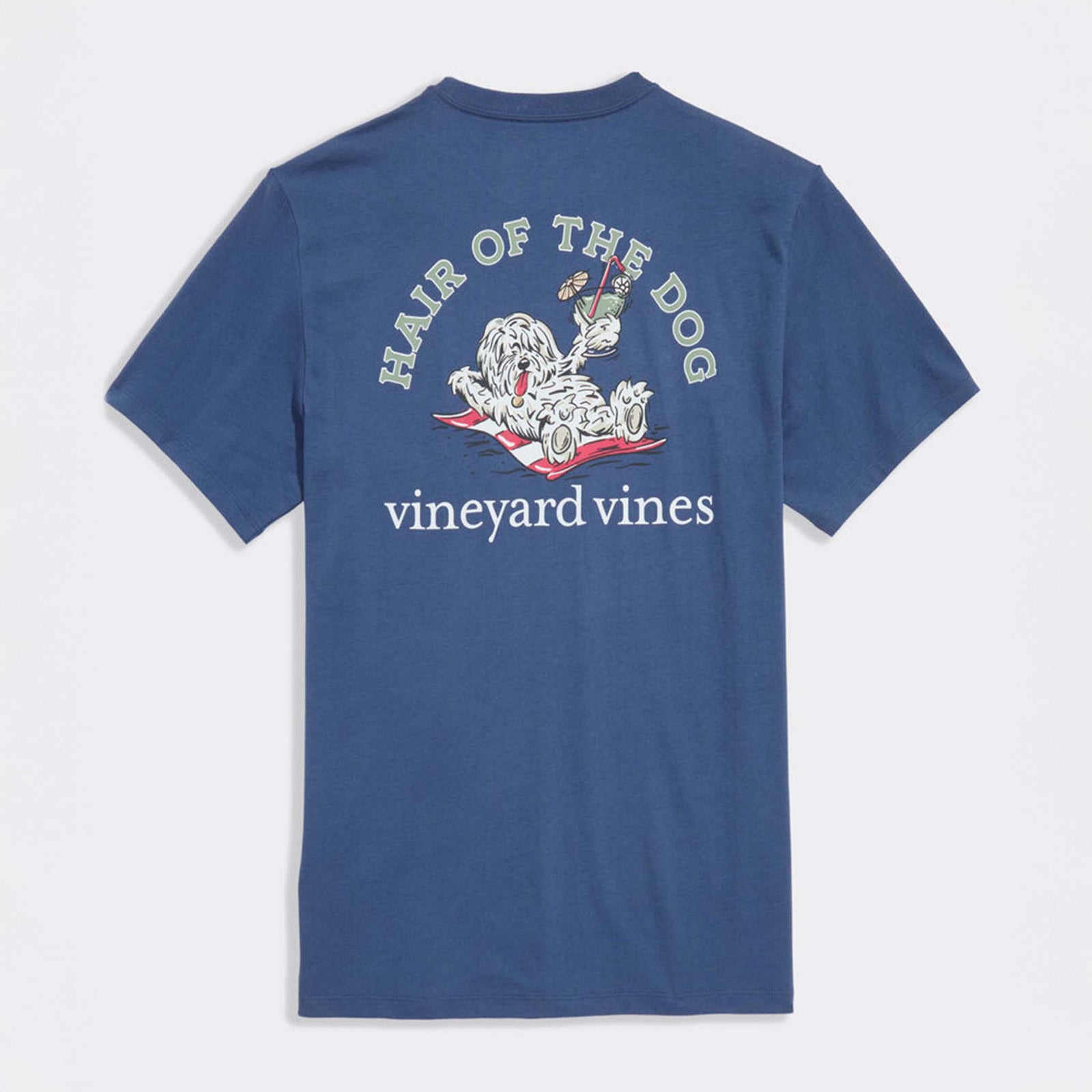 Back view of blue Vineyard Vines t-shirt featuring large “Hair of the Dog” graphic with shaggy dog reclining on a towel holding a cocktail.