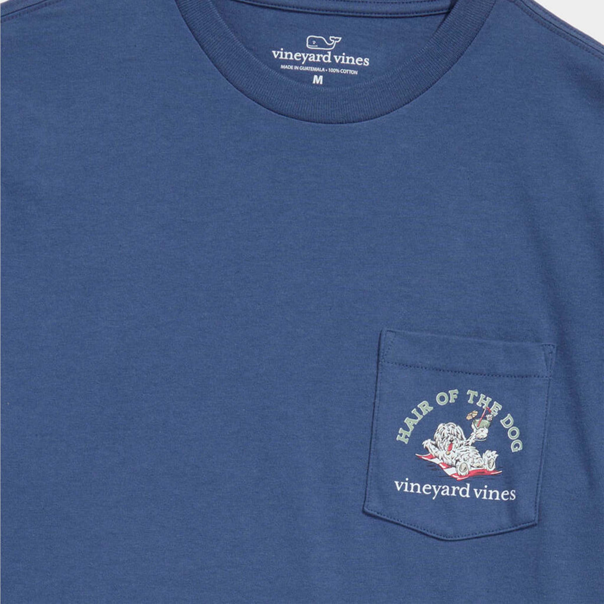 Close-up of front pocket showing Vineyard Vines “Hair of the Dog” graphic with lounging dog holding a drink.