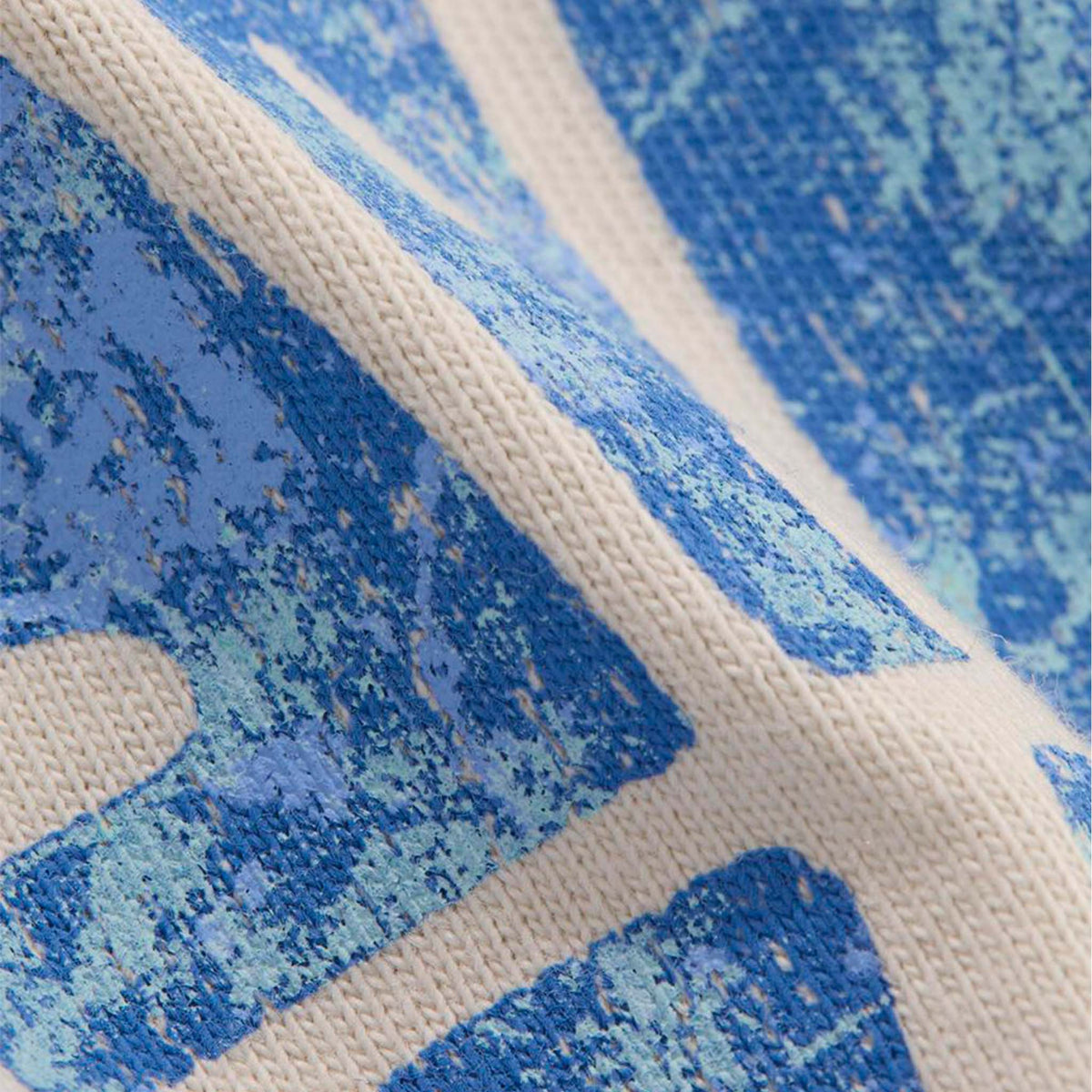 Close-up of a textured fabric with blue and beige pattern
