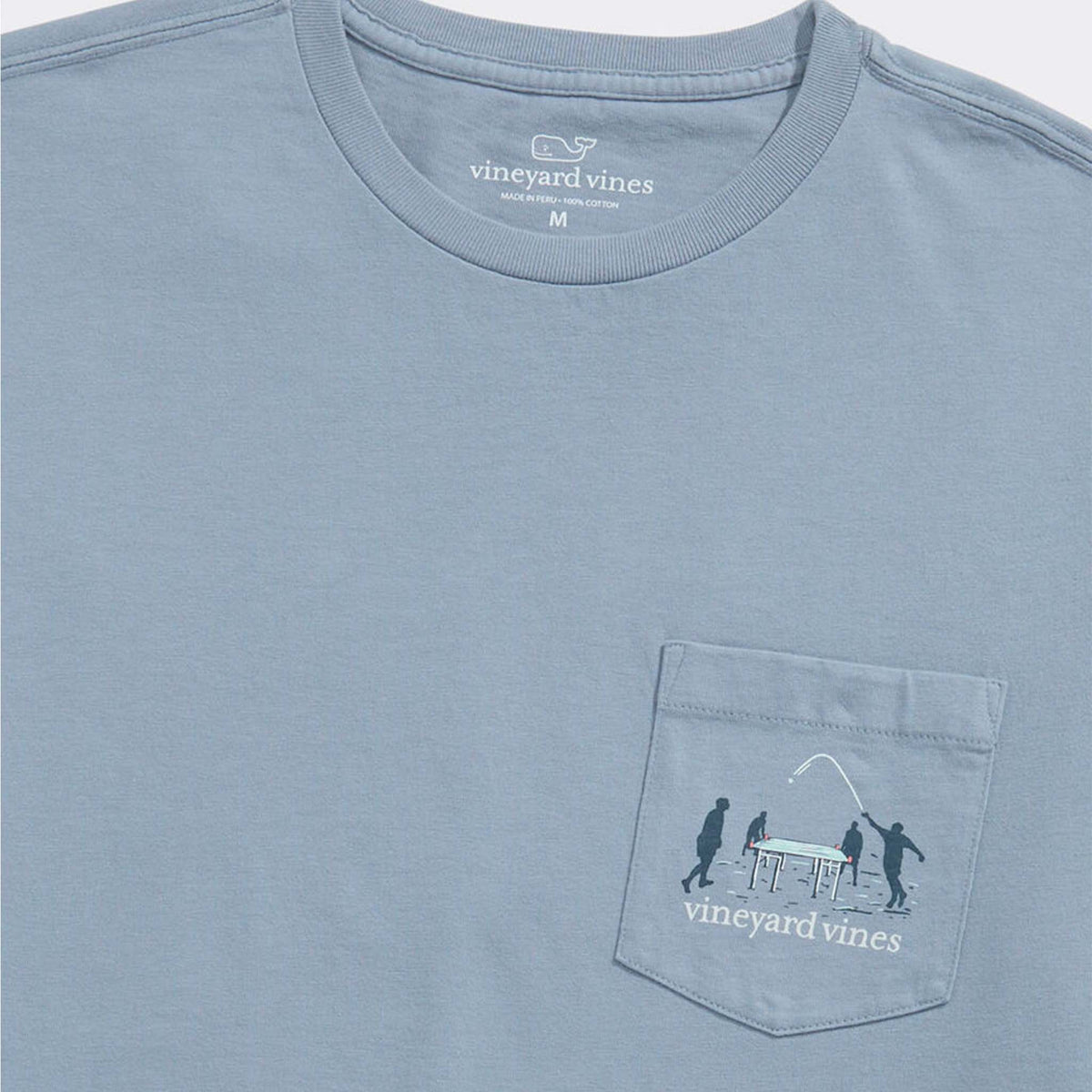 Close-up of front pocket design showing silhouettes playing beach game around a table with Vineyard Vines logo.
