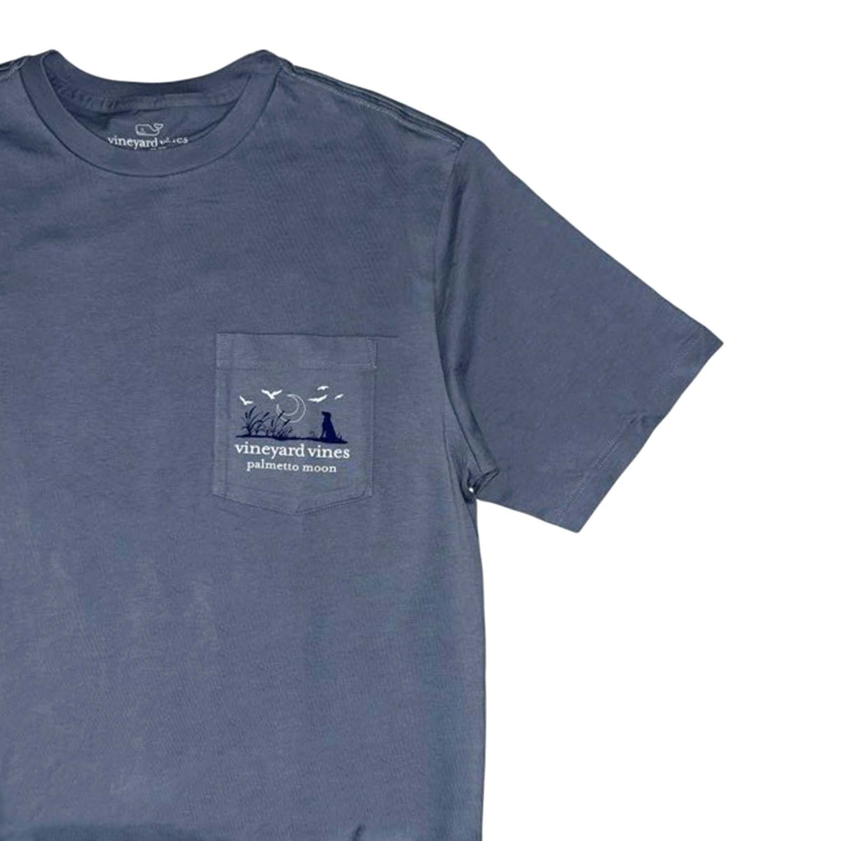 Blue t-shirt with a pocket design featuring 'Vineyard Vines' branding on a white background.