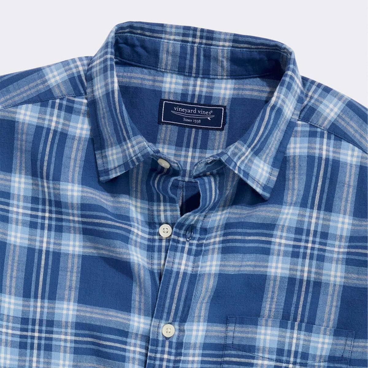 Collar and chest detail of Vineyard Vines blue plaid button-down shirt with label.