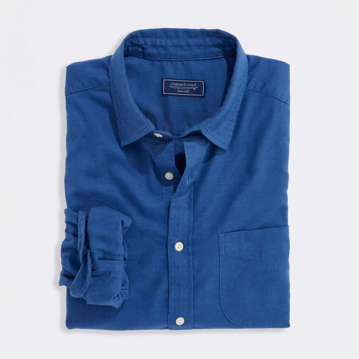 Folded Vineyard Vines solid Moonshine blue long sleeve button-down shirt with chest pocket.