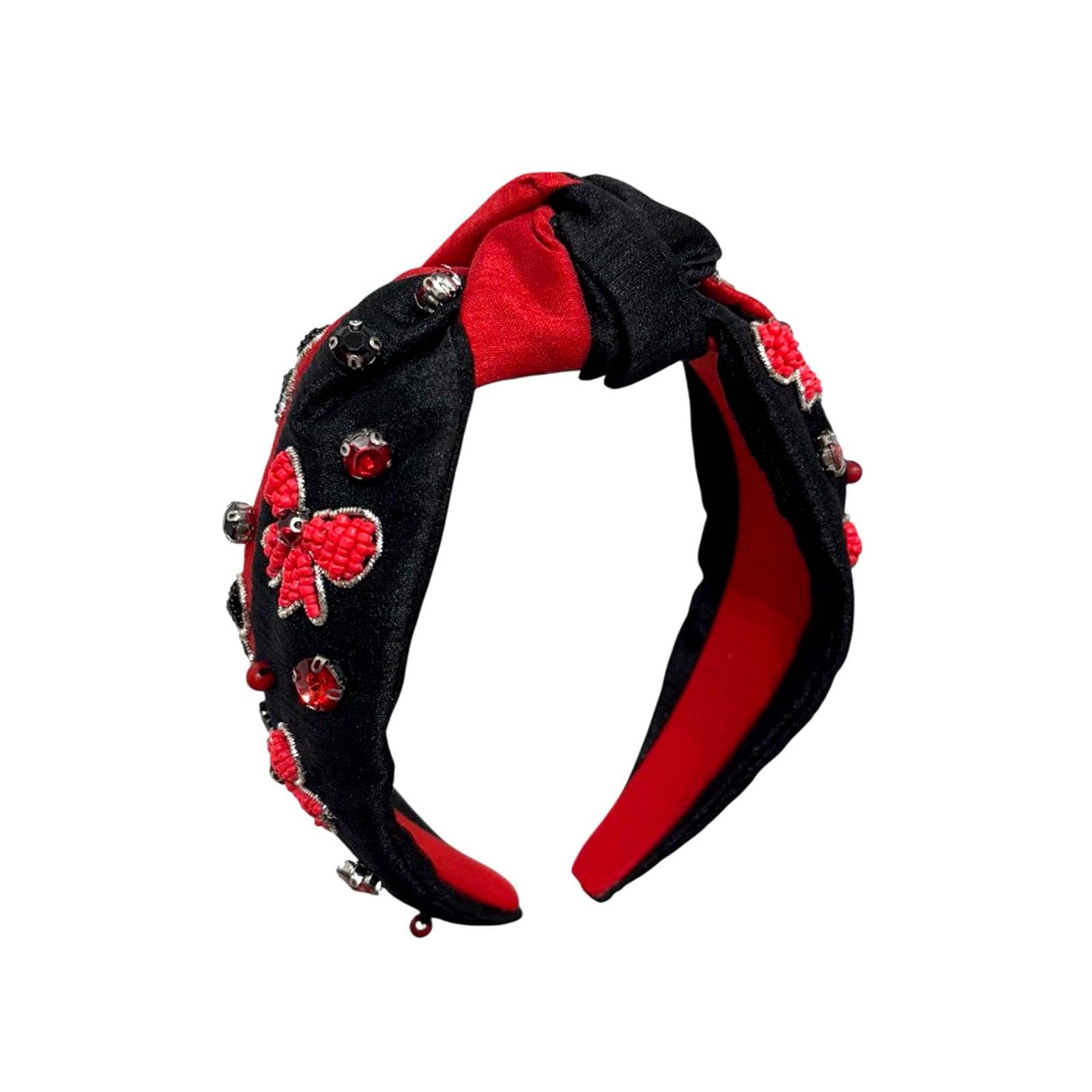 Black and red knotted headband with beaded red bows and gem embellishments on black side.