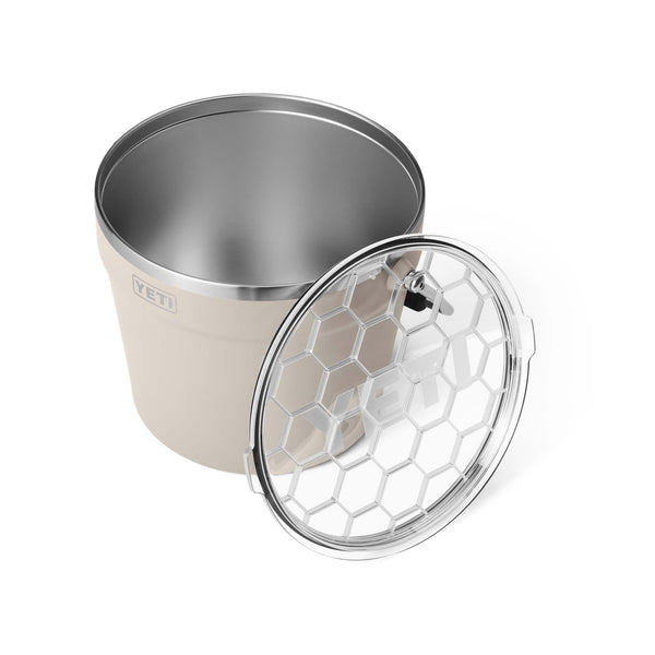 Beige and silver insulated container with honeycomb pattern on lid on a white background