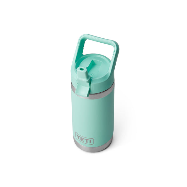 Seafoam green 12-ounce YETI Rambler Jr. Kids Bottle made of durable stainless steel with double-wall vacuum insulation, a leak-resistant straw cap, and a sturdy carrying handle; features the YETI logo on the front and a wide-mouth opening for easy cleaning.
