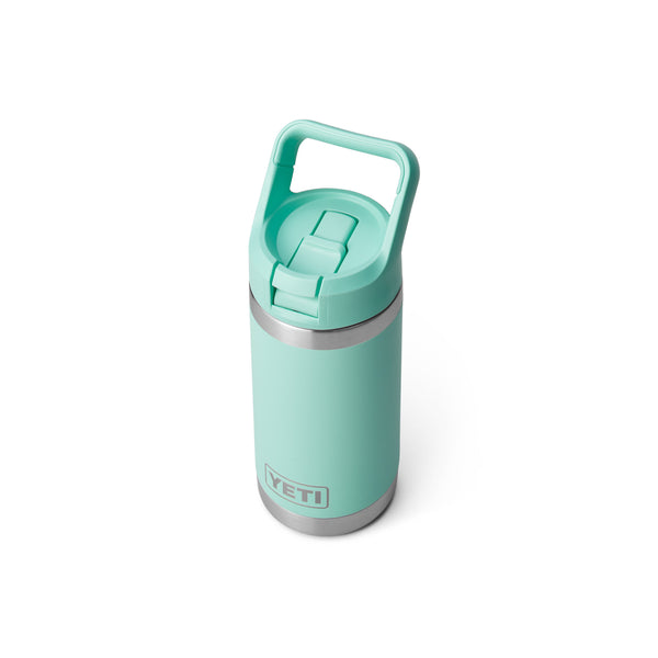 Seafoam green 12-ounce YETI Rambler Jr. Kids Bottle made of durable stainless steel with double-wall vacuum insulation, a leak-resistant straw cap, and a sturdy carrying handle; features the YETI logo on the front and a wide-mouth opening for easy cleaning.