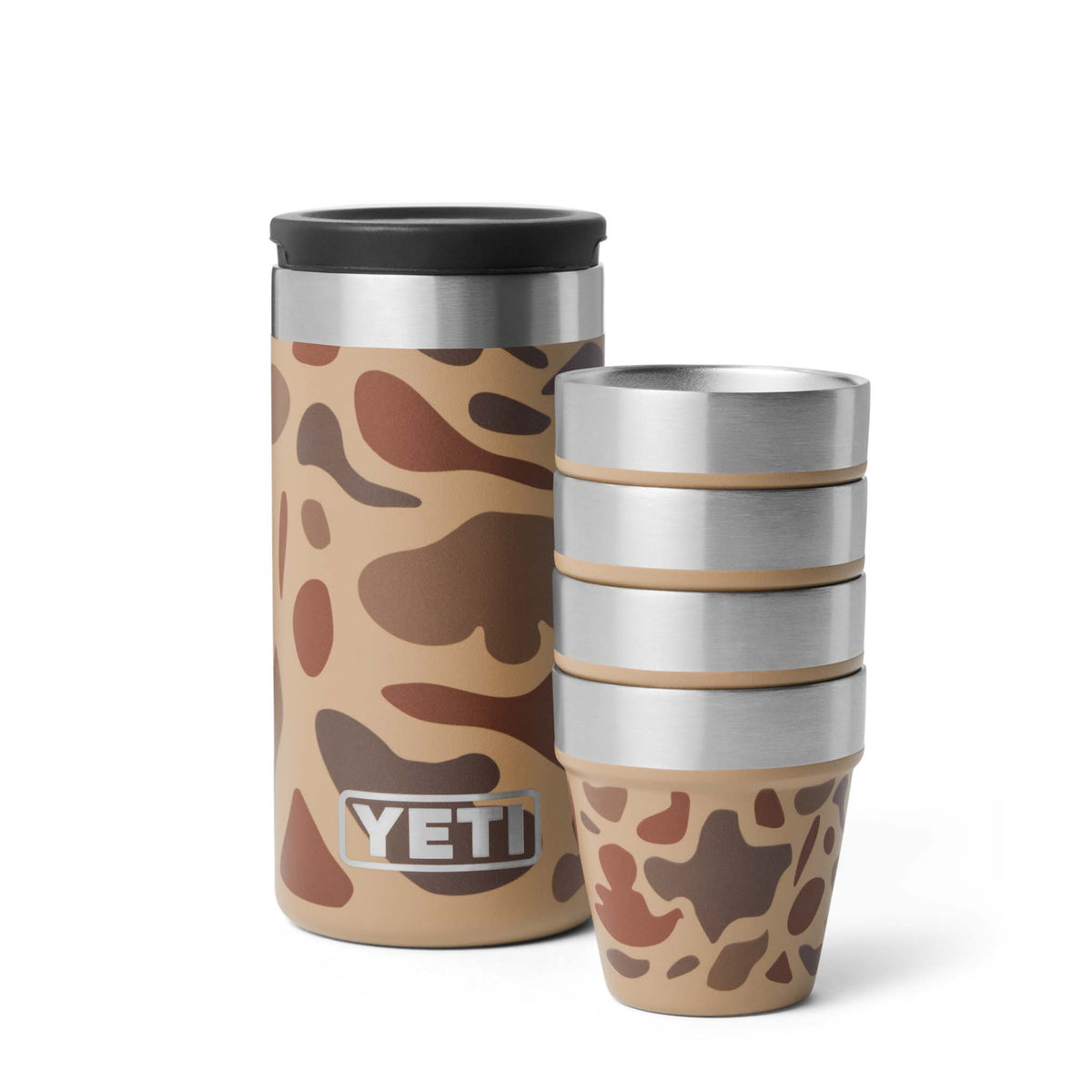 Four YETI Wetlands Camo shot cups next to open canister with lid, shown on white background.