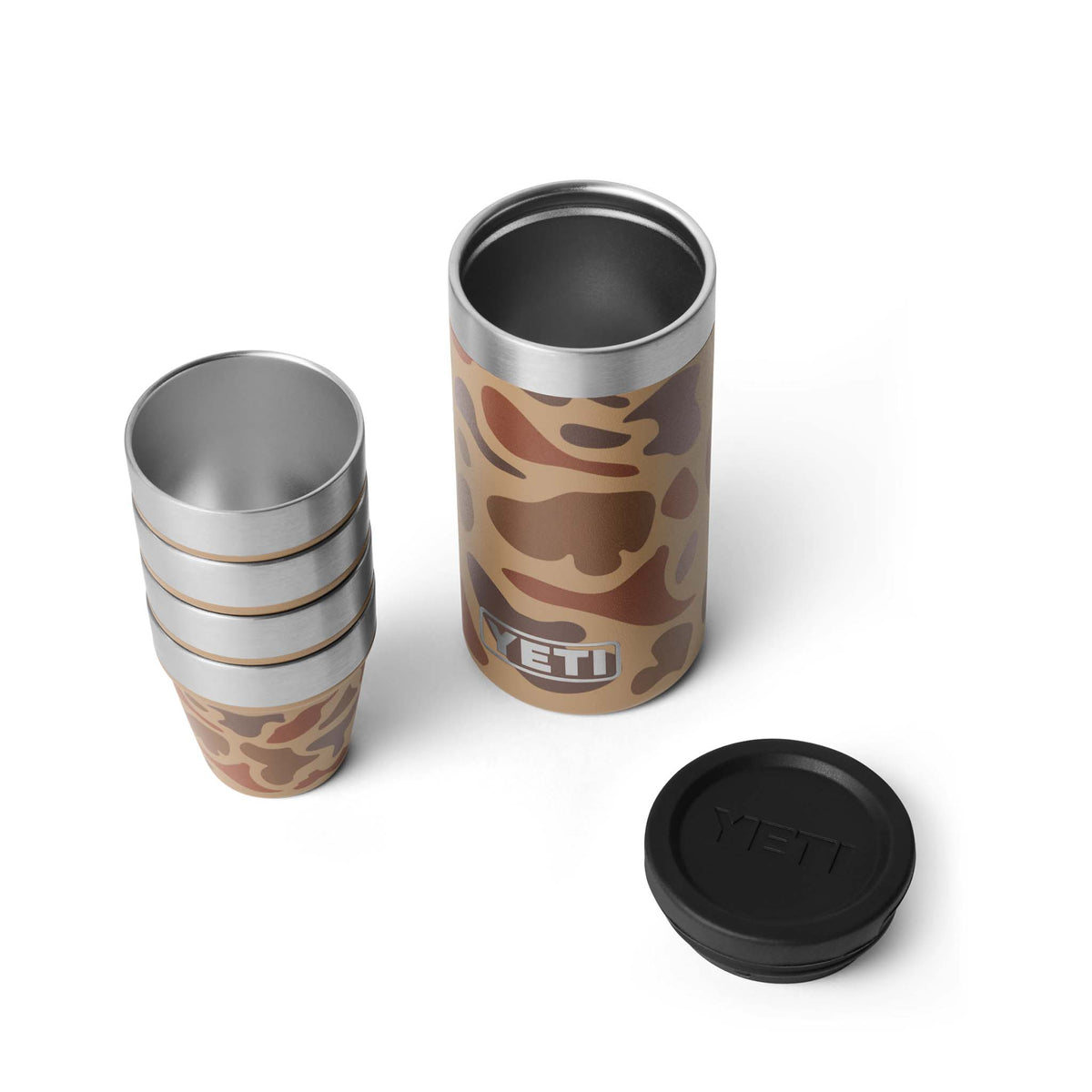 Four YETI Wetlands Camo shot cups next to open canister with lid, shown on white background.