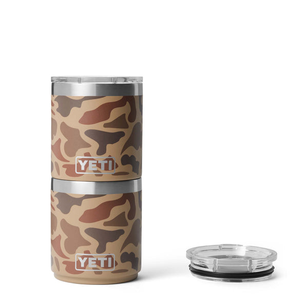Two stacked YETI 10 oz mugs in Wetlands Camo with clear lids, shown next to a separate clear lid with black gasket ring.