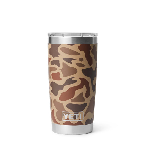 Back view of YETI Rambler tumbler in Wetlands Camo with stainless YETI logo at the bottom over a tan and brown camo pattern.