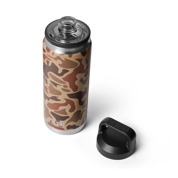 Side view of YETI 26 oz Chug Bottle in Wetlands Camo with black Chug Cap detached and placed beside it.