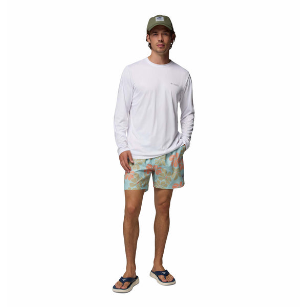  Man wearing a white long-sleeve shirt, colorful shorts, and a cap on a white background