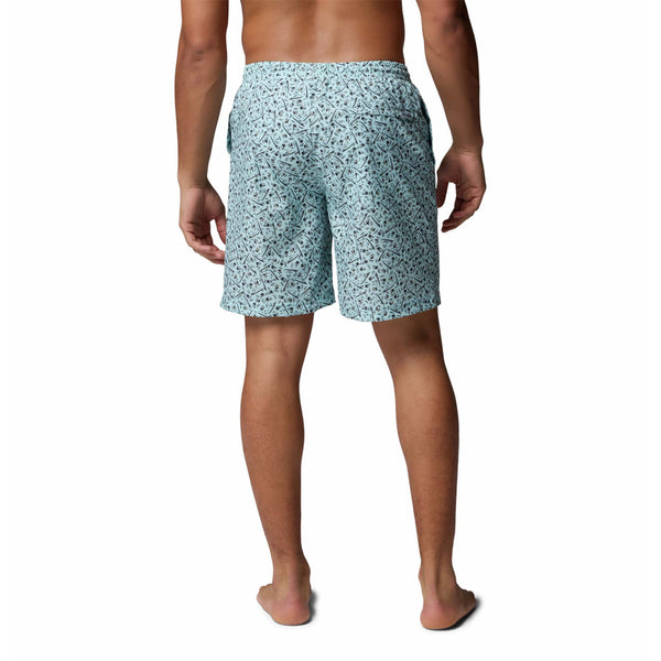  Person wearing light blue patterned swim shorts on a white background