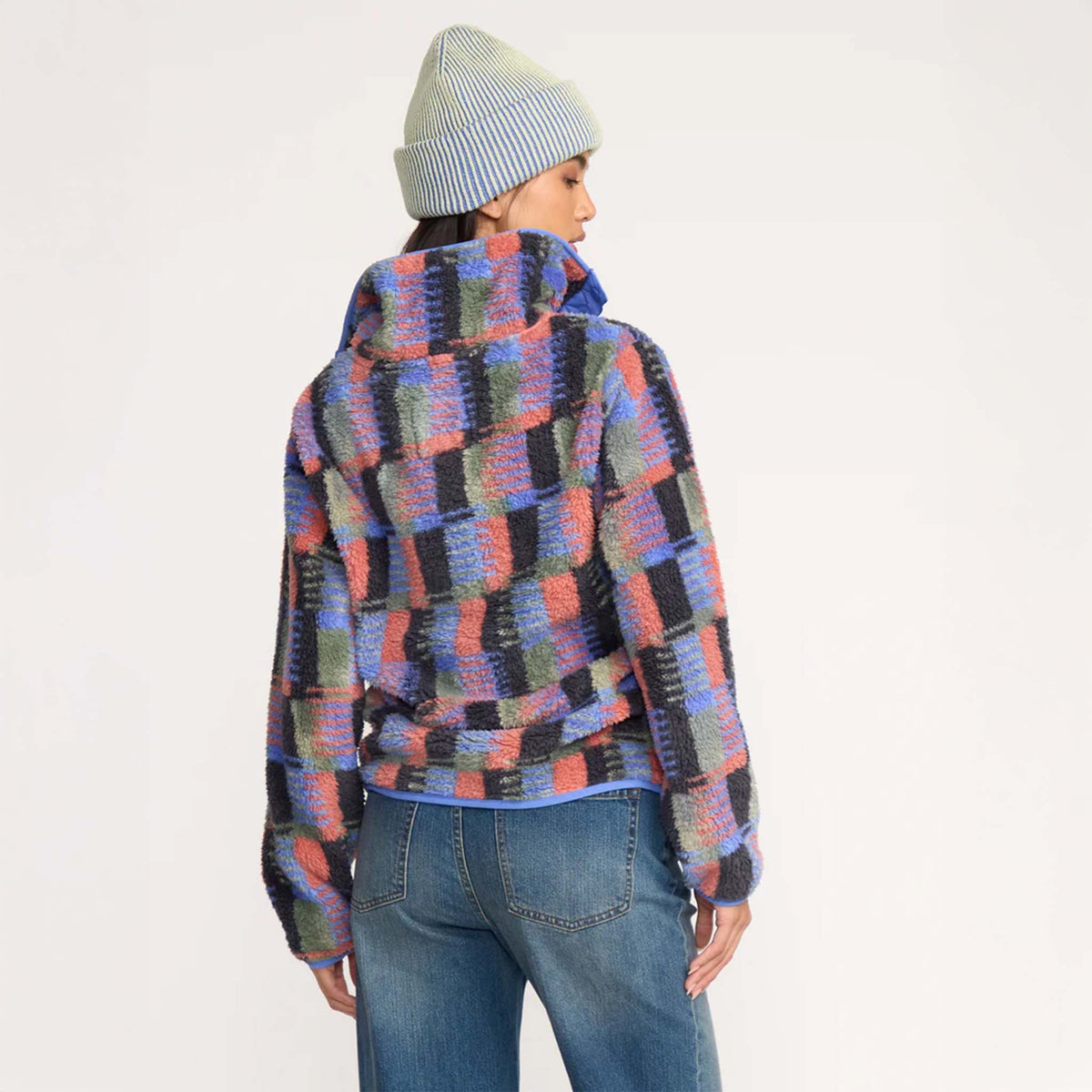 Back view of woman wearing multicolor plaid sherpa pullover showing relaxed fit and high collar detail.