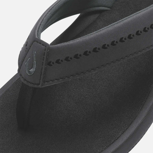 Close up of Olukai Women's Ulele Sandal in Black shown on a white background.