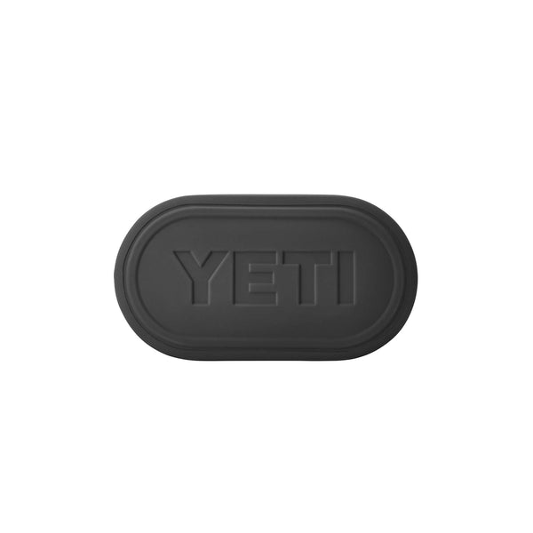 Close-up of black embossed YETI logo on the bottom of the Storm Gray Camino Carryall 35.