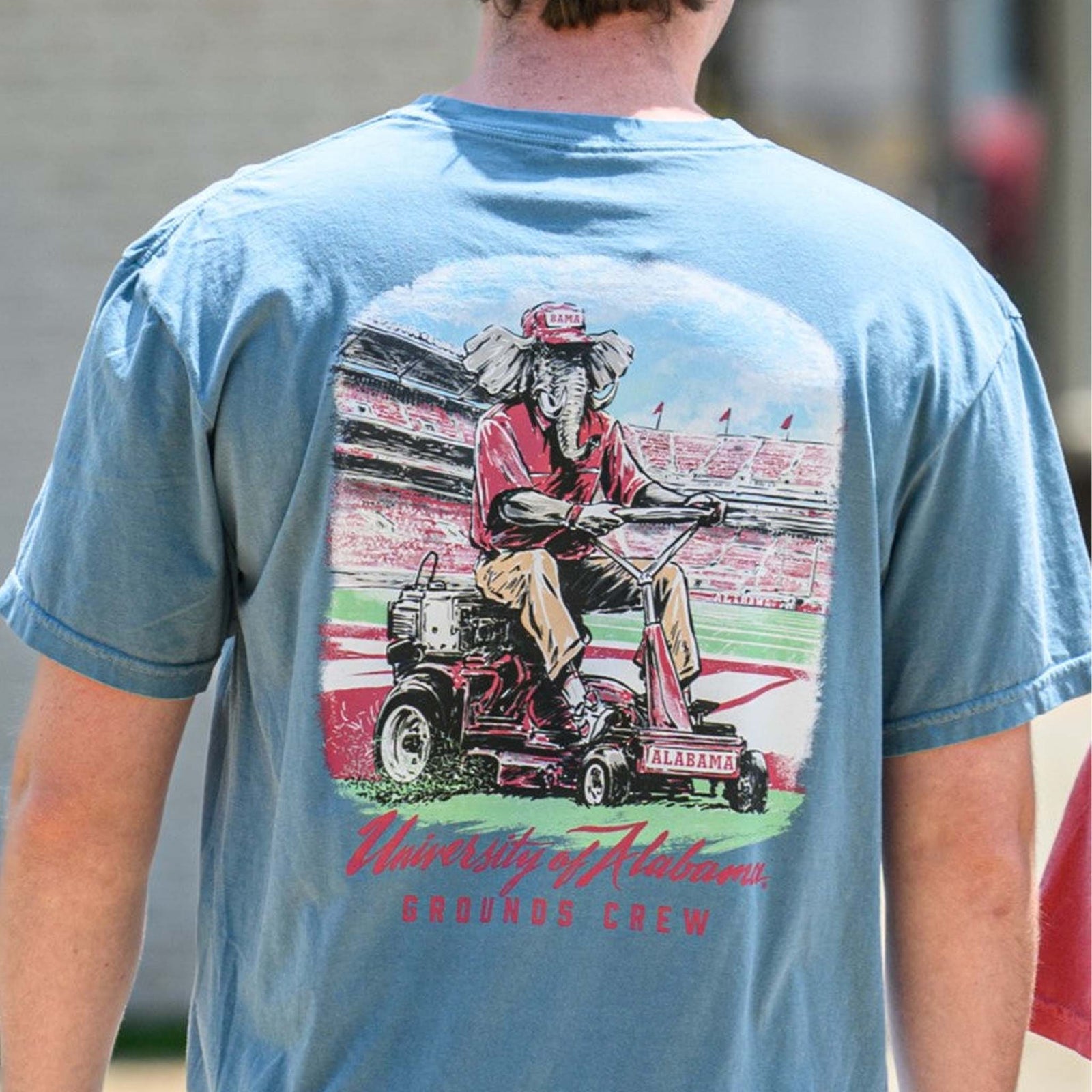 Back view of Big Al Grounds Crew tee showing graphic of Alabama mascot mowing the field inside the stadium.